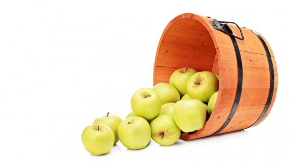 Studio shot of yellow apples in a wooden bucket